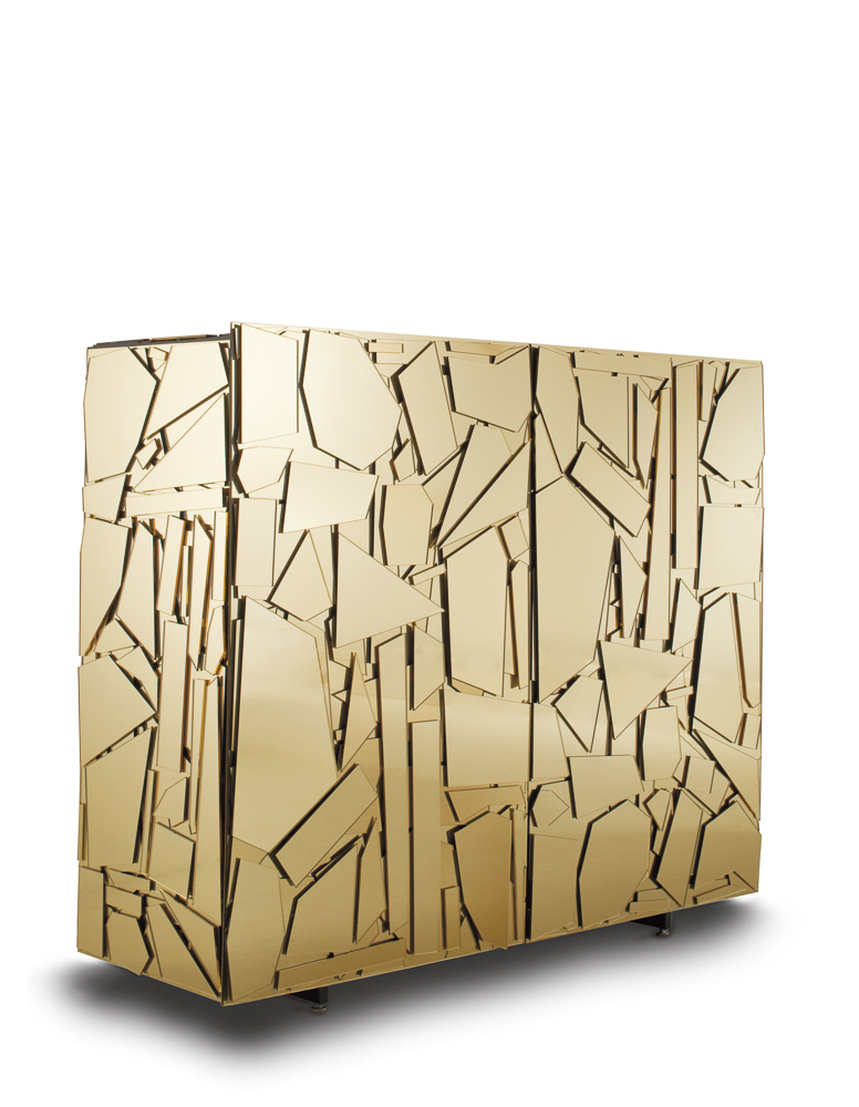 A geometric, gold sideboard with an abstract pattern of irregularly shaped, reflective panels covering its surface. The design creates a fragmented and modern look.